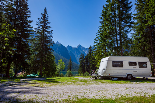 Family vacation travel, holiday trip in motorhome RV, Caravan car Vacation. Beautiful Nature Italy natural landscape Alps.