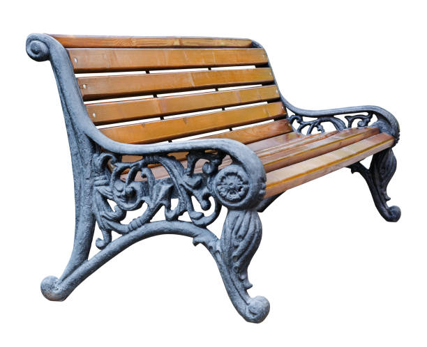 istock Perspective view on a brown wooden bench with wrought legs with ornate patterns, isolated on a white background (design element) 1128694942