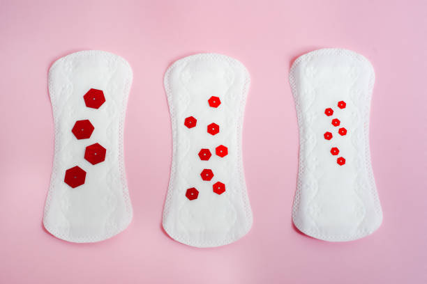 menstrual pads with red glitter over pink background. Menstrual blood loss. minimal concept, flat lay over head. stock photo