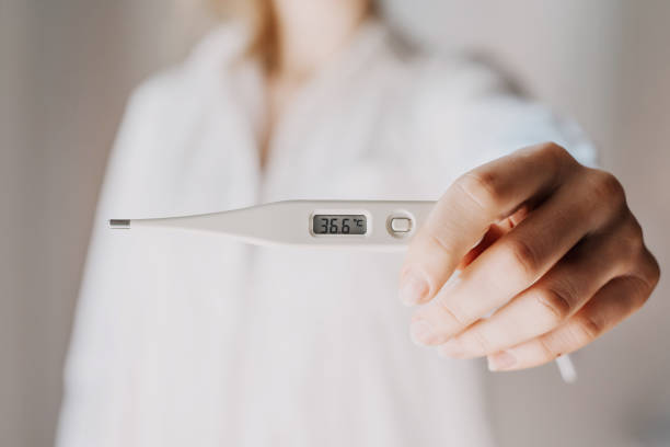 female caucasiam doctor holding digital thermometer on life style background, closeup. Medical stock photo