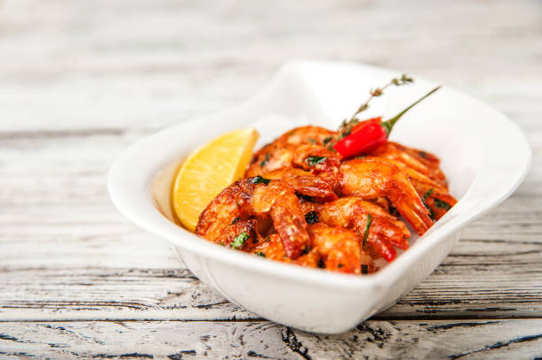 istock Grilled prawns with garlic, chilli peppers and tomatoes close-up and copy space 1128696318