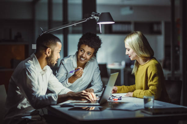 istock Business People Working Late in The Office 1128696548