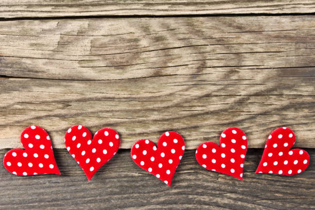 istock Red decoration hearts against wooden background 1128698650