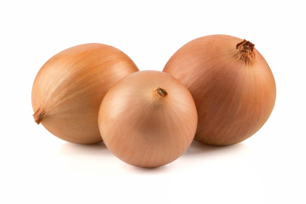istock heap of fresh beige onion bulb isolated on white background 1128698716