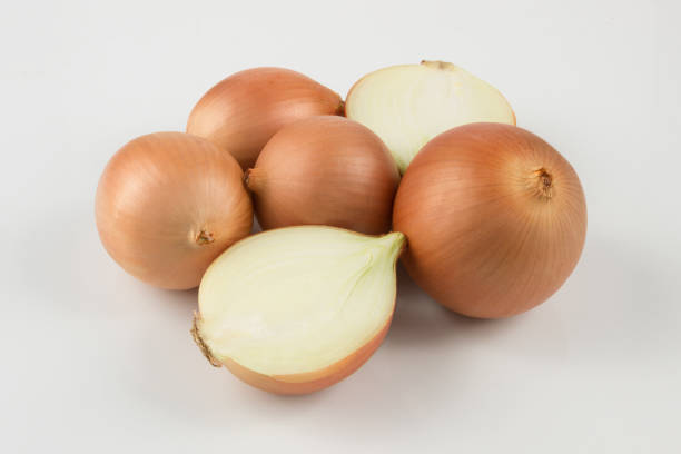 istock heap of fresh beige onion bulb on white background 1128698731