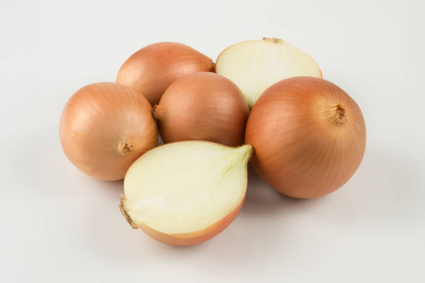 istock heap of fresh beige onion bulb on white background 1128698732