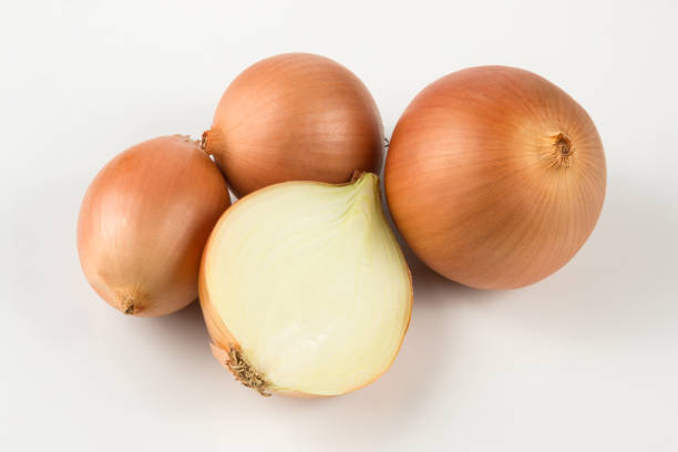istock heap of fresh beige onion bulb on white background 1128698736