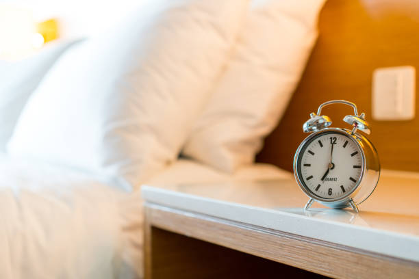 istock Metal Alarm clock on white bedroom 1128698926