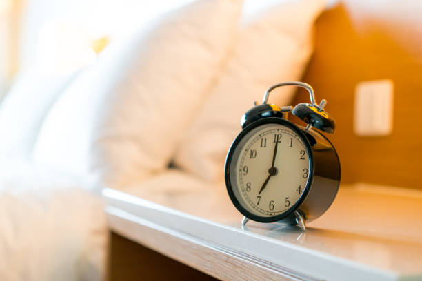 istock Metal Alarm clock on white bedroom 1128698929