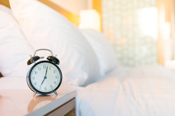 istock Metal Alarm clock on white bedroom 1128698936