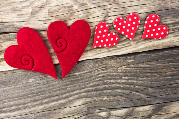 istock Red decoration hearts against wooden background 1128699022