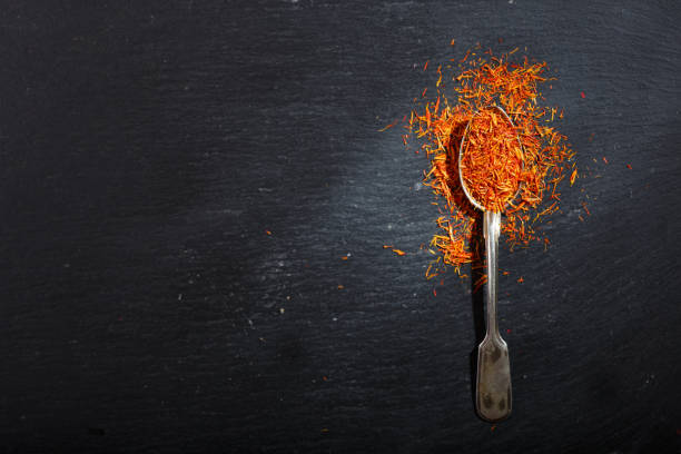 istock dried saffron spice in a spoon on dark table 1128699073
