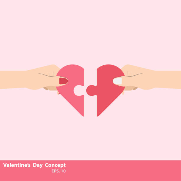 istock Two hand holding connecting two a piece jigsaw of love 1128702387