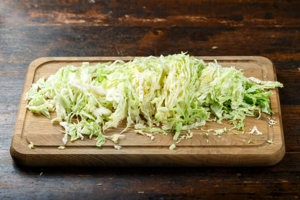 istock finely chopped savoy cabbage on wooden background. 1128702726