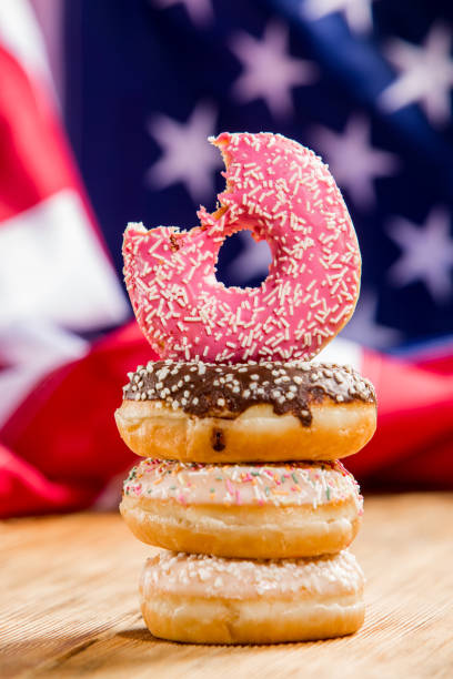 istock Sweet  donuts isolated over waving american flag 1128705024