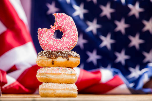istock Sweet  donuts isolated over waving american flag 1128705031