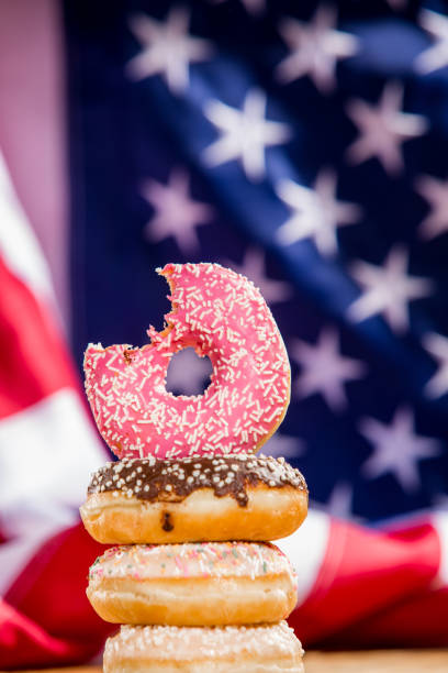 istock Sweet  donuts isolated over waving american flag 1128705032