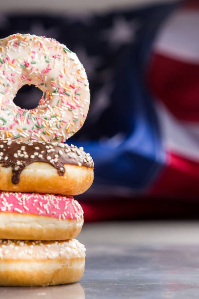istock Sweet  donuts isolated over waving american flag 1128705046
