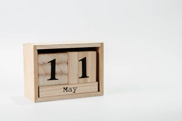 istock Wooden calendar May 11 on a white background 1128705104