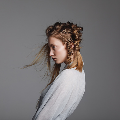 Portrait of young beautiful woman with braids