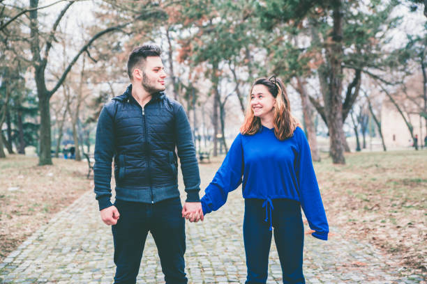 istock Couple walking in park 1128709190