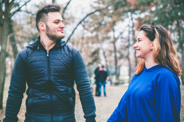 istock Couple walking in park 1128709361