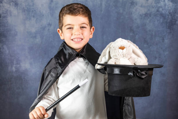 istock Little magician doing a trick with a rabbit 1128709473