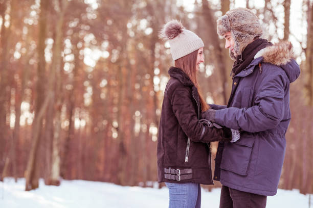 istock Young couple is walking in the forest during winter. 1128711057