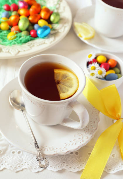 istock Easter mood: cup of lemon tea drink with colorful candy 1128714765