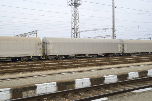 istock Gray freight train with tented wagons on railway 1128715556