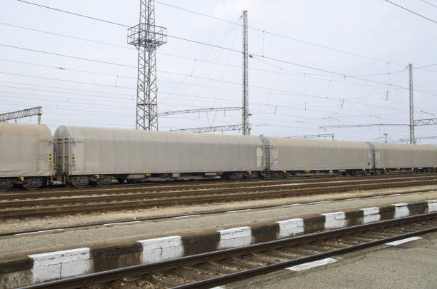 istock Gray freight train with tented wagons on railway 1128715578
