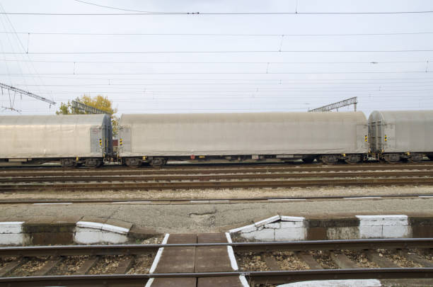 istock Gray freight train with tented wagons on railway 1128715579