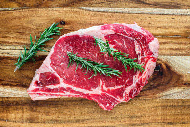 istock Beef steak bone in with rosemary on wooden cutting board 1128717029