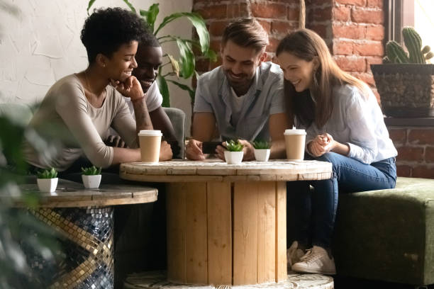 istock Diverse friends spending free time together in coffee house 1128717631