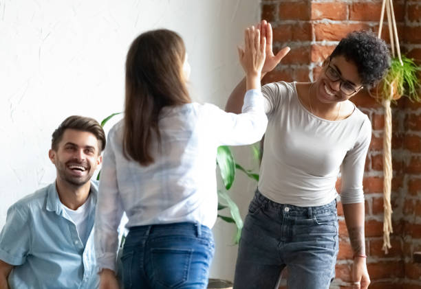 istock Friends giving high five greeting each other 1128717643