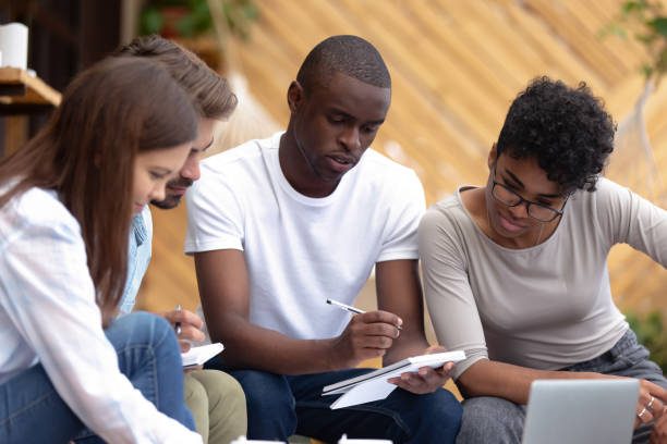 smart students learning together sitting in cozy place - african descent american culture exercising women imagens e fotografias de stock