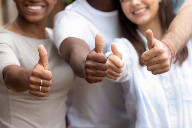 istock Close up diverse people showing thumbs up 1128717749