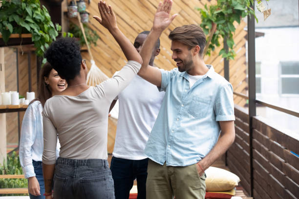 istock Multiracial people standing in summer terrace giving high five 1128717755
