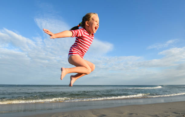 istock Little pretty girl on summer beach. 1128717839