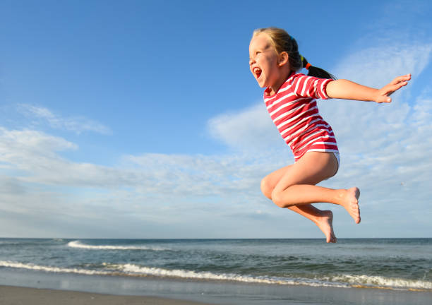 istock Little pretty girl on summer beach. 1128717959
