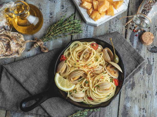 istock Pasta with seafood, shellfish clams in the iron pan portion, with lemon and seasoning 1128719499