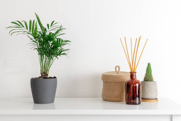 istock Scandinavian nordic hygge style, home interior - candle, scent aroma diffuser, small straw basket, white shelf 1128723337