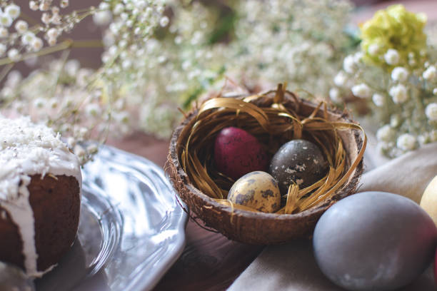 istock Close up of coloured decorated easter eggs in coconut shel 1128724180