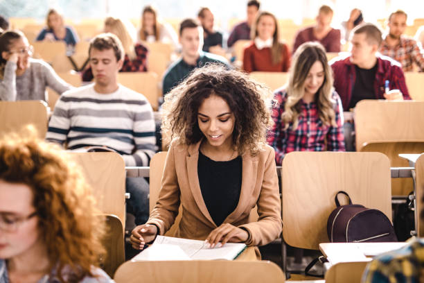 istock Happy student reading a lecture on a class in the classroom. 1128724308