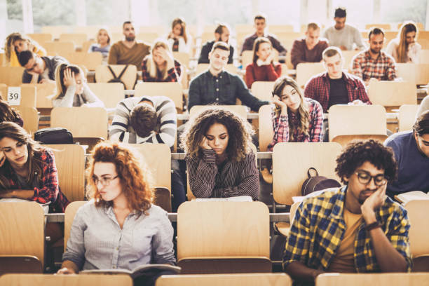 istock Large group of bored college students in a lecture hall. 1128724344