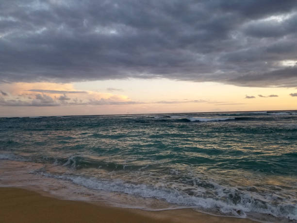 Dramatic Dusk light over the ocean on Kaimana Beach