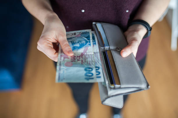 istock Woman taking out money from wallet 1128725927