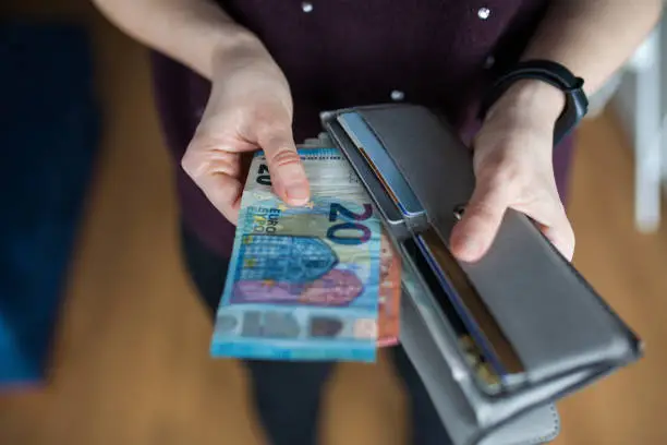 Photo of Woman taking out money from wallet