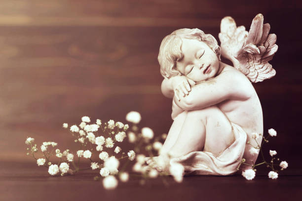 istock Angel and white flowers 1128732904