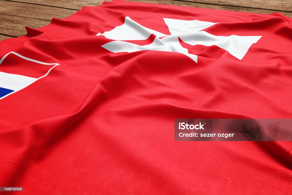 Flag of Wallis And Futuna on a wooden desk background. Silk flag top view. Banner - Sign Stock Photo